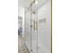 Close up of a glass shower with designer tile, gold trim and fixtures and a built in niche at 5610 N River Shore Dr, Tampa, FL 33603
