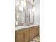 Elegant bathroom featuring dual sinks, marble countertops, and stylish lighting, creating a spa-like experience at 5610 N River Shore Dr, Tampa, FL 33603