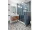Chic bathroom featuring a glass shower, decorative floor tiles, and a floating wood vanity at 5610 N River Shore Dr, Tampa, FL 33603