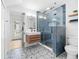 Contemporary bathroom with unique floor tiles, a floating vanity, and a glass-enclosed shower for a sleek design at 5610 N River Shore Dr, Tampa, FL 33603