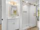 Beautiful bathroom with a glass shower, gold fixtures, and stylish white vanity with designer tile and quartz counters at 5610 N River Shore Dr, Tampa, FL 33603