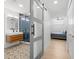 Modern bathroom with glass shower, decorative tile floor, floating vanity and a view to the bedroom at 5610 N River Shore Dr, Tampa, FL 33603