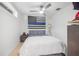 Modern bedroom with ceiling fan and an American flag above the bed at 5610 N River Shore Dr, Tampa, FL 33603