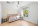 Bright bedroom with a gold metal bed frame, white walls and wood floor at 5610 N River Shore Dr, Tampa, FL 33603