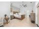 Spacious bedroom featuring hardwood floors, modern decor, and access to a luxurious ensuite bathroom at 5610 N River Shore Dr, Tampa, FL 33603
