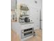 Stylish coffee bar with built-in microwave, mosaic backsplash, and open shelving for mugs and decor at 5610 N River Shore Dr, Tampa, FL 33603