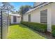 Well-maintained exterior featuring a manicured lawn, storage shed, and defined property lines at 5610 N River Shore Dr, Tampa, FL 33603