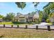 Beautiful two-story home featuring a manicured lawn and a charming covered porch at 5610 N River Shore Dr, Tampa, FL 33603