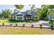 Beautiful two story home featuring a manicured lawn and a charming covered porch at 5610 N River Shore Dr, Tampa, FL 33603