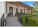 Inviting front porch with comfortable seating, lantern accents, and mature landscaping at 5610 N River Shore Dr, Tampa, FL 33603