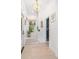 Bright hallway featuring wood floors, a staircase, natural light, and flamingo wallpaper in the powder room at 5610 N River Shore Dr, Tampa, FL 33603