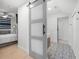 Hallway with view to bedroom and bathroom, stylish patterned floor tiles and a sliding door at 5610 N River Shore Dr, Tampa, FL 33603