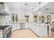 Beautiful white kitchen featuring granite countertops and stainless steel appliances at 5610 N River Shore Dr, Tampa, FL 33603