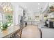 Well-lit kitchen with stainless steel appliances and adjacent breakfast nook at 5610 N River Shore Dr, Tampa, FL 33603