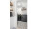 Cozy laundry room with stylish tile floors, side-by-side washer and dryer, and wood shelving at 5610 N River Shore Dr, Tampa, FL 33603
