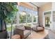 Comfortable living room featuring large windows with water views, a floor lamp, and cozy armchairs at 5610 N River Shore Dr, Tampa, FL 33603