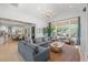 Open floor plan with a spacious living room featuring a chandelier, large windows, and water views at 5610 N River Shore Dr, Tampa, FL 33603
