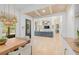 Bright, open-concept living room with wood beam ceilings and decorative built-in shelving at 5610 N River Shore Dr, Tampa, FL 33603