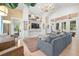 Spacious living room features a large sofa, built-in shelves, tv and decor, and access to the outside at 5610 N River Shore Dr, Tampa, FL 33603