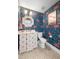 Powder room with flamingo wallpaper, white vanity, modern fixtures, and basket weave tile floor at 5610 N River Shore Dr, Tampa, FL 33603