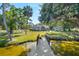 Scenic waterfront property featuring a dock and lush landscaping, offering serene views at 5610 N River Shore Dr, Tampa, FL 33603