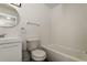 Clean bathroom with white fixtures, a round mirror and subway tile at 5670 Postma St, North Port, FL 34287