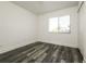 Well-lit bedroom showcasing wood flooring, a window, and neutral color palette at 5670 Postma St, North Port, FL 34287