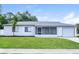 Charming single-story home features a well-maintained lawn, attached garage, and neutral color scheme at 5670 Postma St, North Port, FL 34287