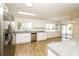 Modern kitchen featuring stainless steel appliances, granite countertops, and tile flooring at 5670 Postma St, North Port, FL 34287