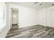 Main bedroom showcasing neutral paint, vinyl flooring, closet, and attached bathroom at 5670 Postma St, North Port, FL 34287
