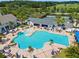 Aerial view of the community pool, clubhouse, tennis courts, and surrounding lush landscaping at 5865 Creek Ridge Rd, Brooksville, FL 34601