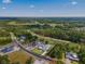 Aerial view of the home and surrounding property on a golf course in a wooded area at 5865 Creek Ridge Rd, Brooksville, FL 34601
