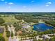 Community aerial view showcasing the pool, lake, golf course and homes at 5865 Creek Ridge Rd, Brooksville, FL 34601