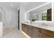 Beautiful bathroom featuring a double vanity with illuminated mirror and marble flooring at 5865 Creek Ridge Rd, Brooksville, FL 34601