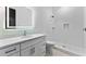 Modern bathroom with a large mirror, quartz countertop vanity, and mosaic tile shower at 5865 Creek Ridge Rd, Brooksville, FL 34601