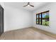 A light, bright and empty bedroom with hardwood floors and a large window at 5865 Creek Ridge Rd, Brooksville, FL 34601