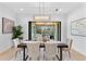 Bright dining room with modern chandelier and views to the backyard through sliding glass doors at 5865 Creek Ridge Rd, Brooksville, FL 34601