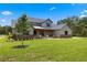 Charming two-story home featuring a landscaped front yard, stone accents, and a welcoming front porch at 5865 Creek Ridge Rd, Brooksville, FL 34601