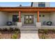 Beautiful front entrance with stone columns, wood beam details, and a brick pathway at 5865 Creek Ridge Rd, Brooksville, FL 34601