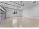 Spacious, three-car garage with epoxy flooring, a rear window, and ample space for storage at 5865 Creek Ridge Rd, Brooksville, FL 34601