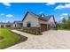 Side view of home with three-car garage, stone accents, and a paved driveway at 5865 Creek Ridge Rd, Brooksville, FL 34601