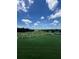 Scenic view of a lush green golf course featuring rolling hills and a sand trap surrounded by mature trees at 5865 Creek Ridge Rd, Brooksville, FL 34601