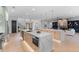A large kitchen featuring an island, bar seating, and sleek appliances adjacent to the living room at 5865 Creek Ridge Rd, Brooksville, FL 34601