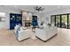 Open-concept living room with a stone fireplace, built-in shelves, and sliding doors to the exterior at 5865 Creek Ridge Rd, Brooksville, FL 34601