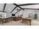 Spacious living room featuring exposed beam ceilings, a flatscreen TV, and a pool table at 5865 Creek Ridge Rd, Brooksville, FL 34601