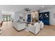 Spacious living room with a stone fireplace, custom blue built-ins, and comfortable seating at 5865 Creek Ridge Rd, Brooksville, FL 34601