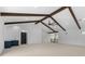 Bright living room features vaulted ceilings, dark wood beams, ceiling fan, carpet and a conveniently-located wet bar at 5865 Creek Ridge Rd, Brooksville, FL 34601