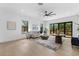 Bright living room features hardwood floors, neutral decor and light filled windows that overlook the outdoor living space at 5865 Creek Ridge Rd, Brooksville, FL 34601