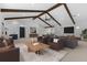 Open-concept living room featuring vaulted ceilings, exposed beams, modern furnishings, and stylish decor at 5865 Creek Ridge Rd, Brooksville, FL 34601