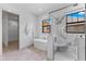 Bright bathroom features a soaking tub and glass shower with marble accents at 5865 Creek Ridge Rd, Brooksville, FL 34601